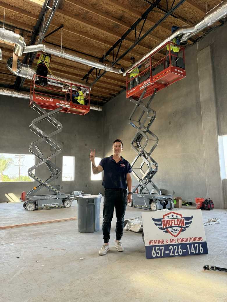 Crew installing overhead ductwork